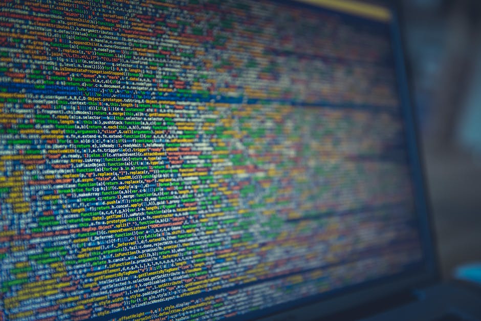 A computer screen displaying a dense display of colorful programming code with lines of text in various colors including blue, green, yellow, red, and white. The code appears to be written in a script